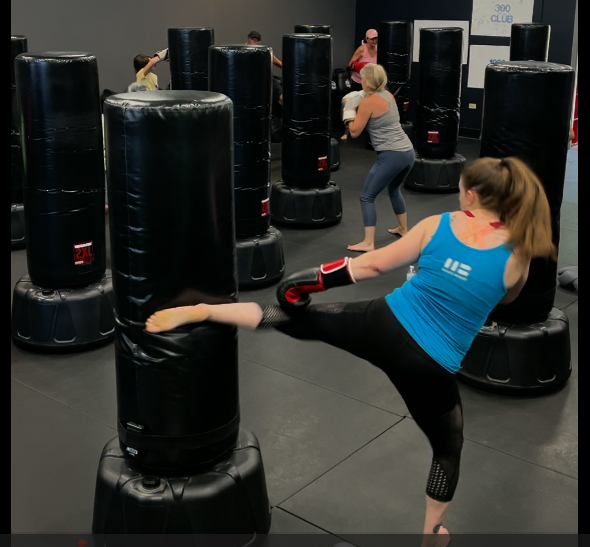 Members kicking heavy bags during a kickboxing class at Thrive Las Vegas
