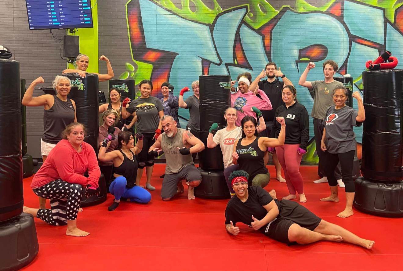 Henderson kickboxing class group photo on the mat at Thrive Kickboxing Henderson NV