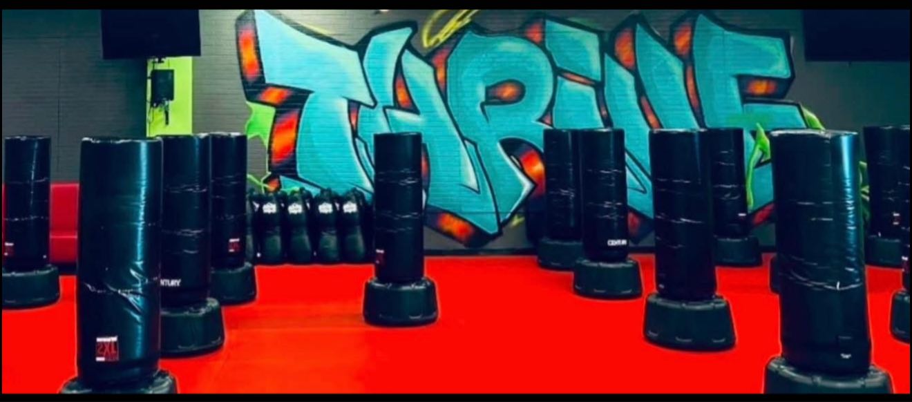 Thrive Kickboxing Henderson studio interior with heavy bags and graffiti wall